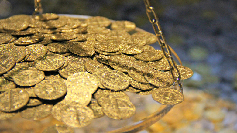 Gold coins on scale