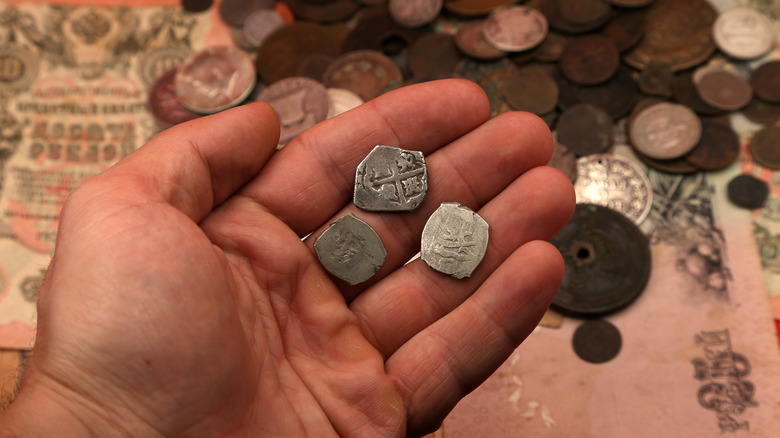 Medieval silver coins in hand