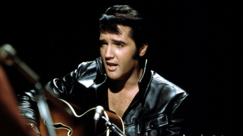 Elvis Presley performing guitar
