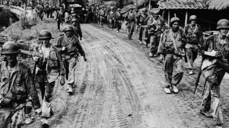 U.S. troops marching dirt road