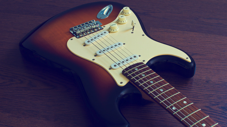 Fender Stratocaster wood and beige guitar on wood table