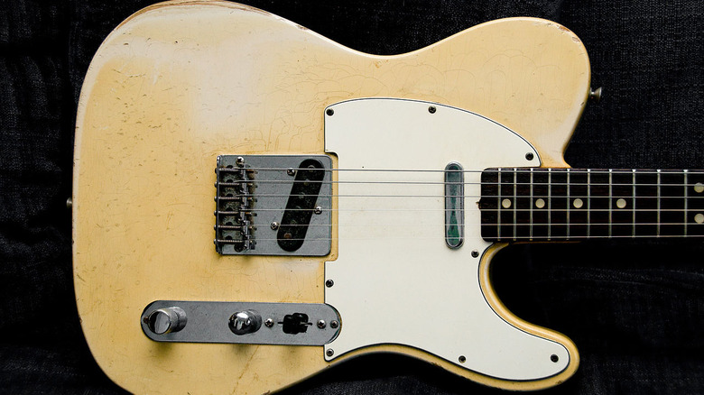 Fender Telecaster aged tan guitar black background