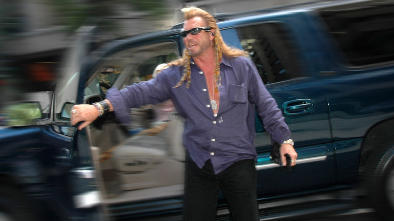 Dog the Bounty Hunter getting out of car, blur