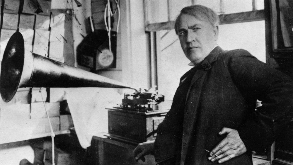 Edison, posing in front of his phonograph invention in 1906.