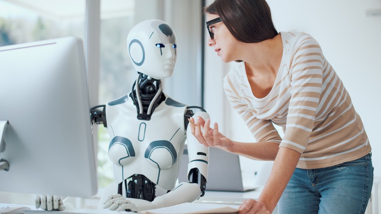Robot and person talking in office