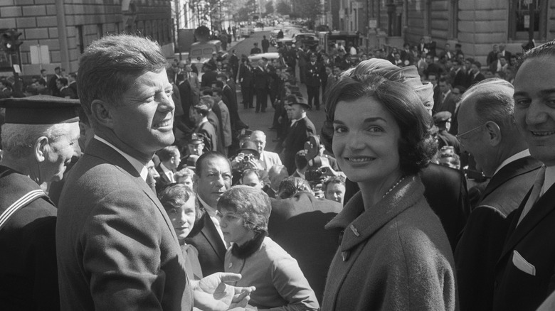 JFK and Jackie Kennedy outside at a parade