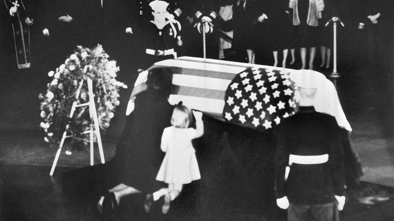 Jackie and Caroline Kennedy kneeling by JFK's casket