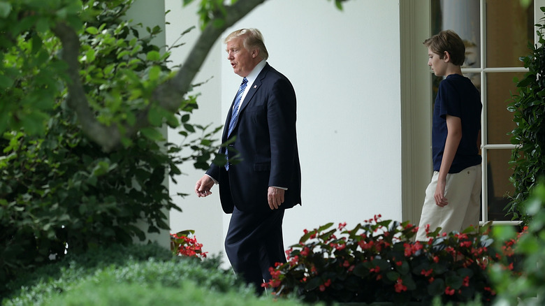 Barron Trump walking behind Donald Trump at the White House