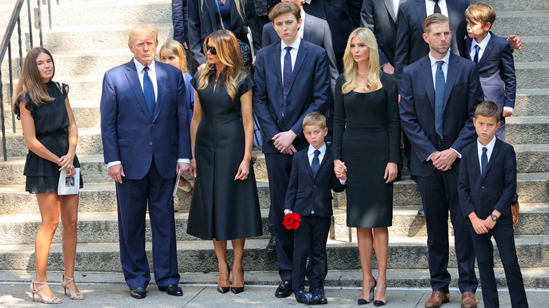 Barron Trump standing with family at funeral