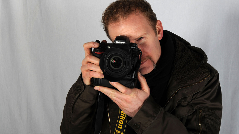 Morgan Spurlock holding a camera