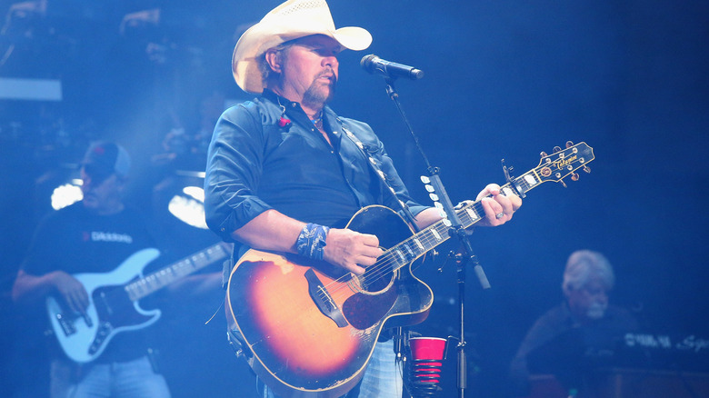 Toby Keith hat playing guitar on stage