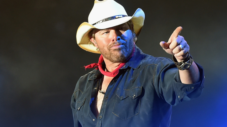 Toby Keith white hat red neckerchief pointing