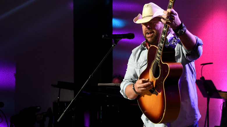 Toby Keith white hat guitar performing on stage