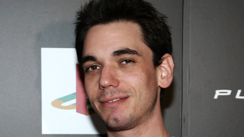 DJ AM poses at an event.