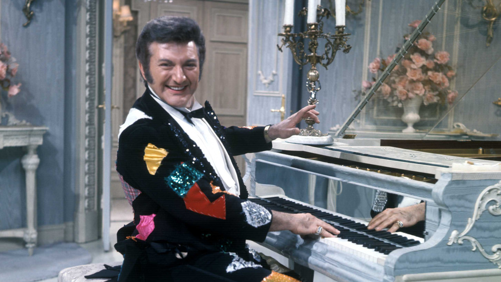 Liberace at the piano