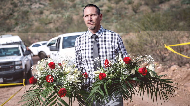 Bryan LeBaron carries flowers to site of LeBaron killings