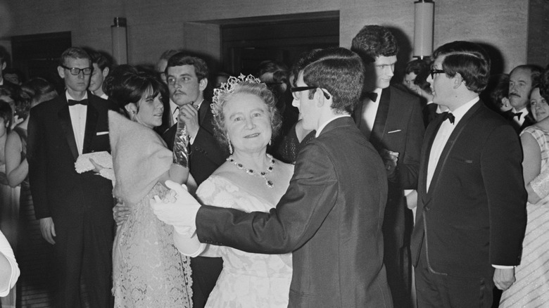 The Queen Mother dancing with young people