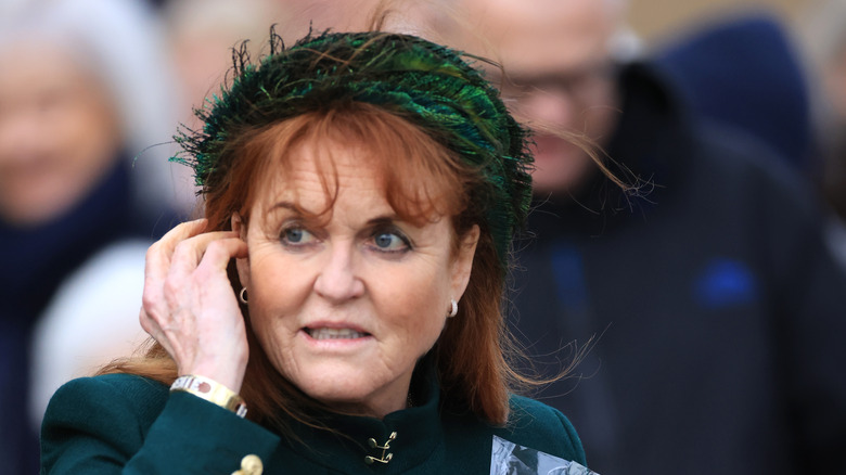 The Duchess of York touching face
