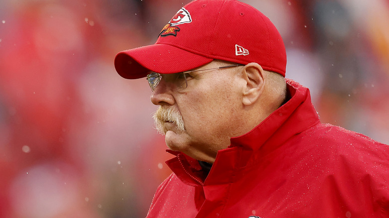 Andy Reid watching from sidelines red cap
