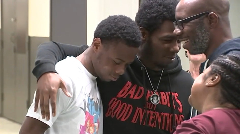 Anthony Alexander Jr is embraced by family