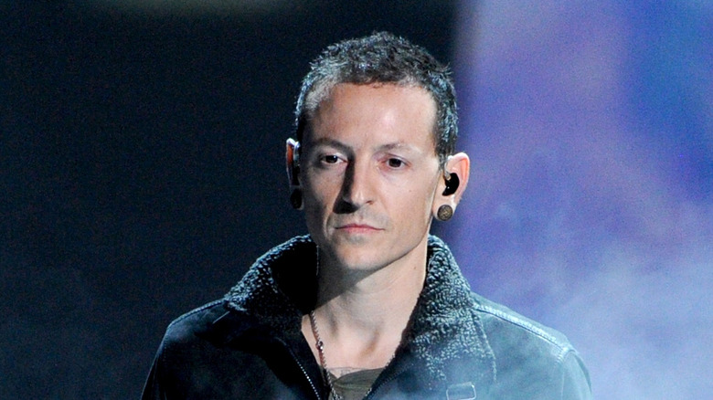 Chester Bennington standing in stage smoke
