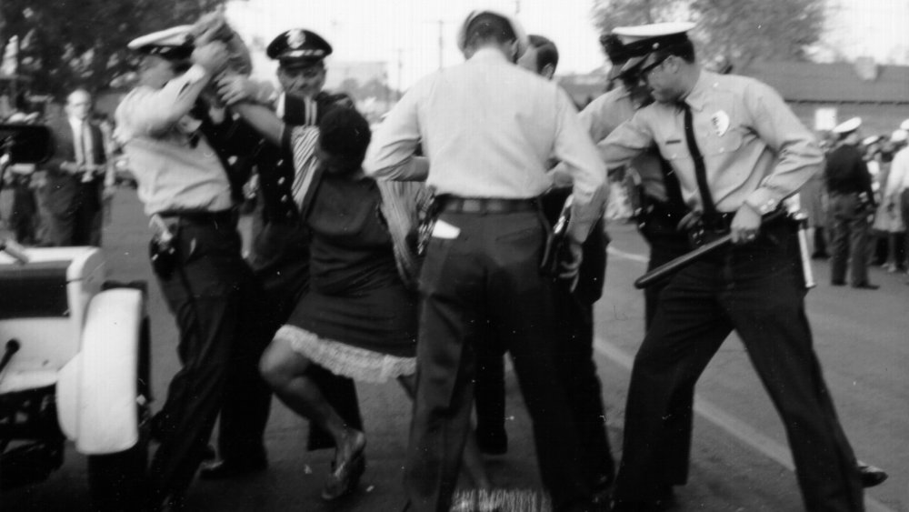 An African American woman fights with policemen during a protest against segregation organized by Reverend Dr. Martin Luther King Jr. and Reverend Fred Shuttlesworth in May 1963