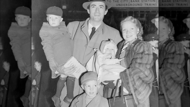 Gregory Peck posing with wife Greta and three sons