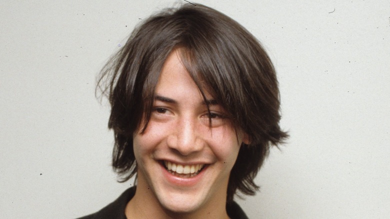 young keanu reeves smiling