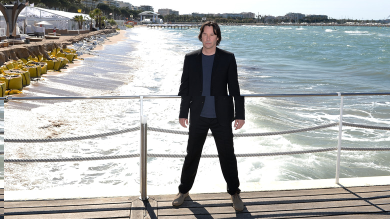 keanu reeves on bridge in front of beach