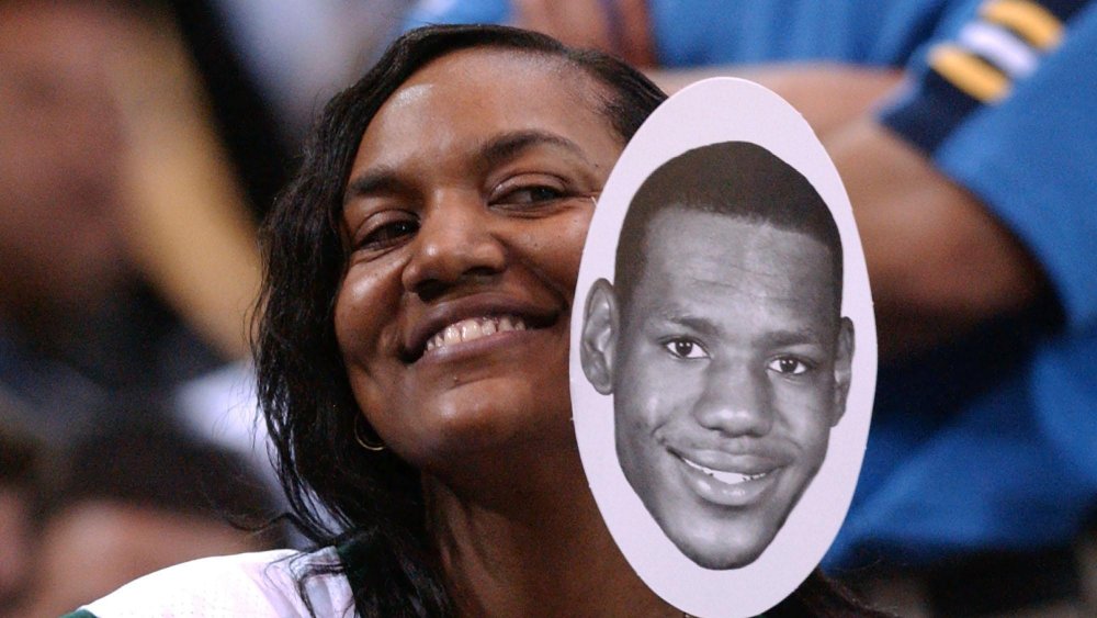 Gloria James smiling holding image of LeBron James