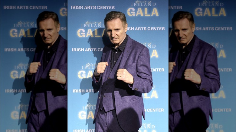 Liam Neeson purple jacket boxing pose