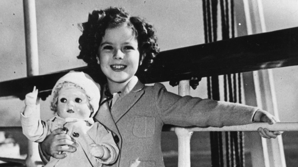 Child filmstar Shirley Temple with her doll on board to Hawai. 1937. Photograph. 