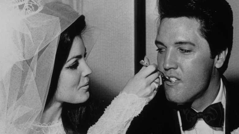 Priscilla Presley feeding Elvis wedding cake