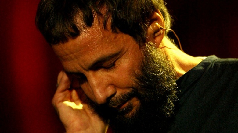 Close-up of Cat Stevens/Yusuf Islam looking down with eyes closed in 2003