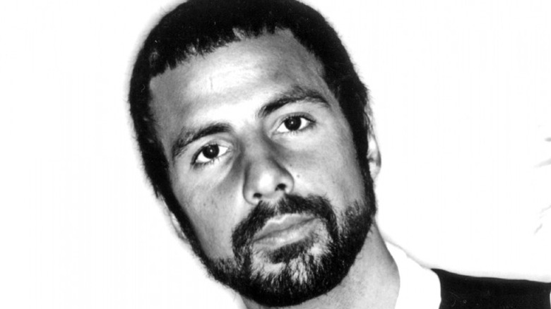 Black and white close-up of an unsmiling Cat Stevens with short hair and beard