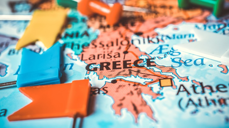 Push pins surround Greece map