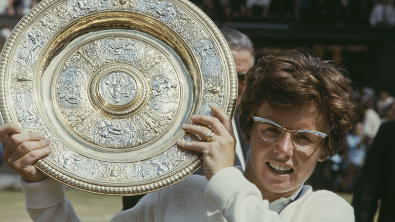 Billie Jean King holding Wimbledon winners' trophy