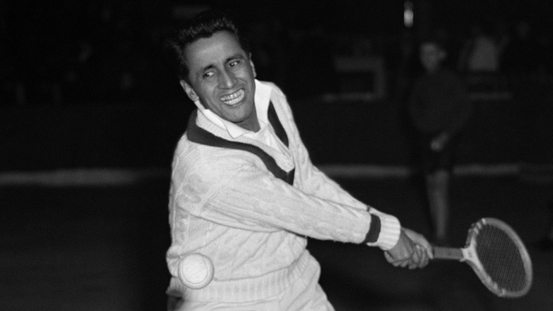 Pancho Segura swinging racquet during match