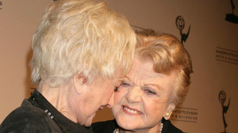Bea Arthur and Angela Lansbury smiling at each other