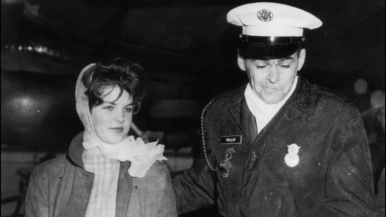 Priscilla Presley smiling with officer