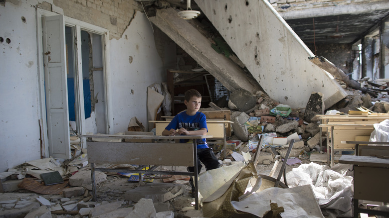 Child in destroyed school, Eastern Ukraine