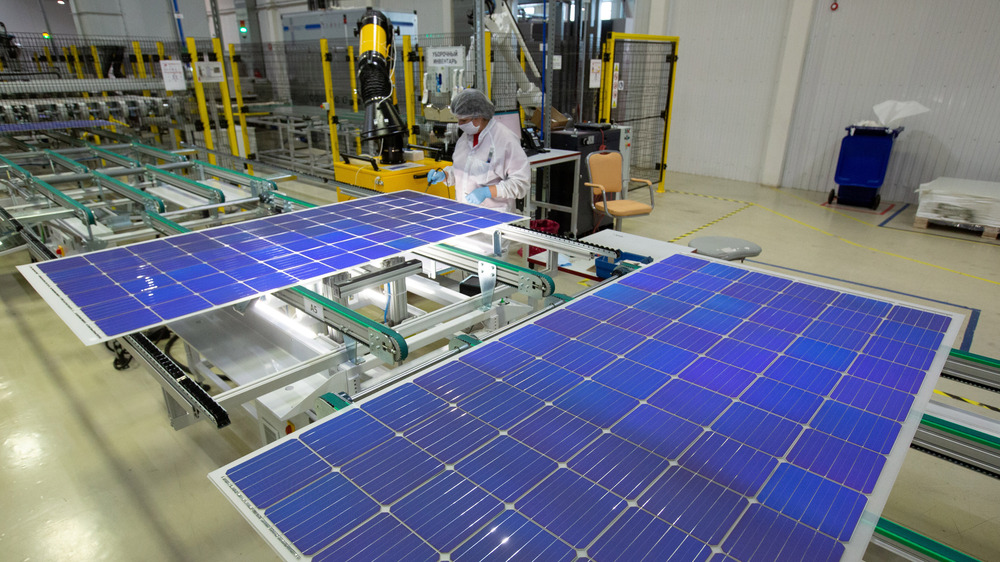 Employee soldering solar panel 