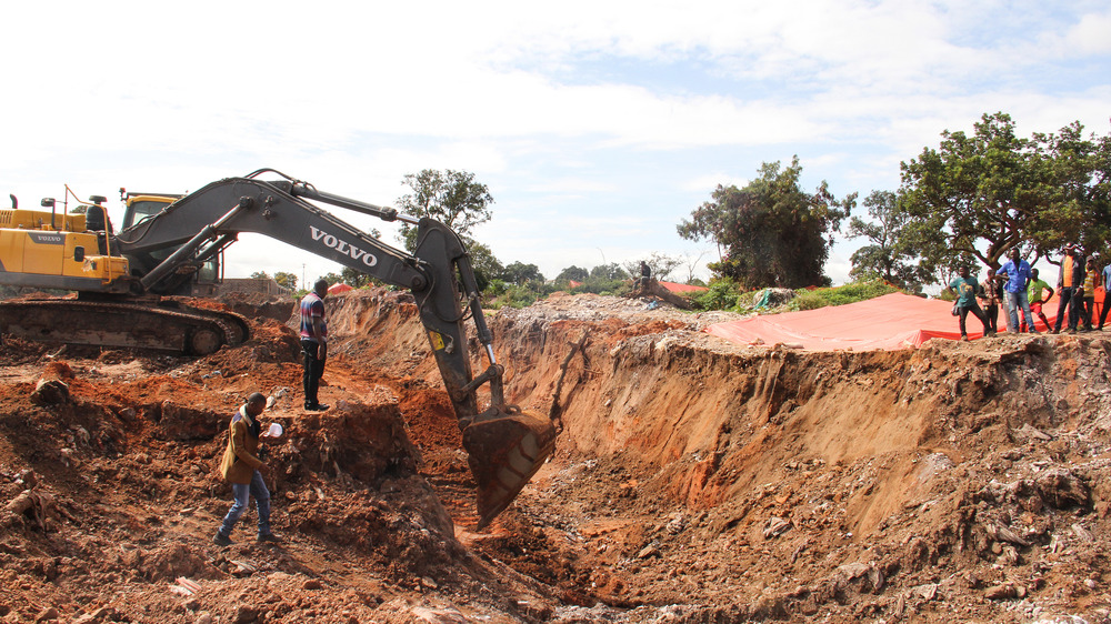 Worker digs pit in artisanal cobalt mine