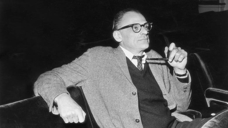 Arthur Miller sitting with pipe