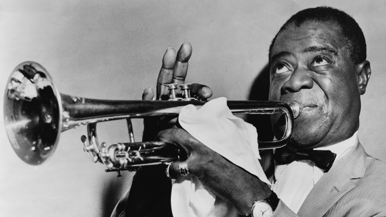 Louis Armstrong playing a trumpet 