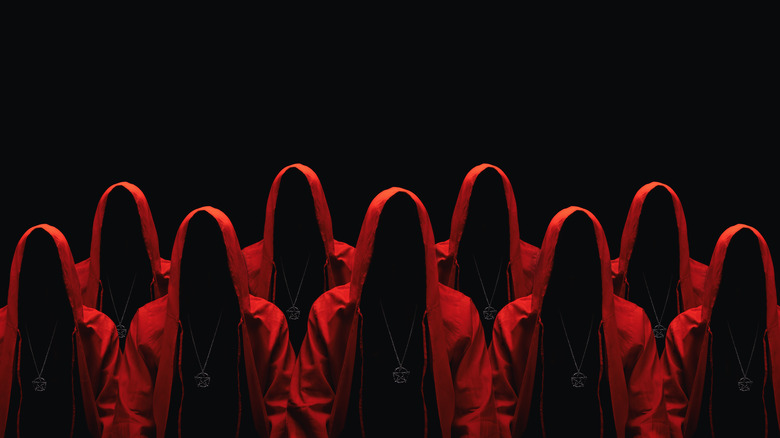 faceless people in red shrouds