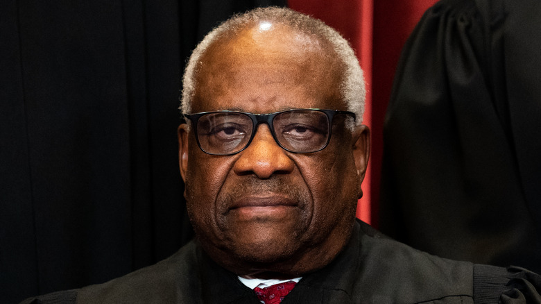 Clarence Thomas frowns during a Supreme Court photoshoot
