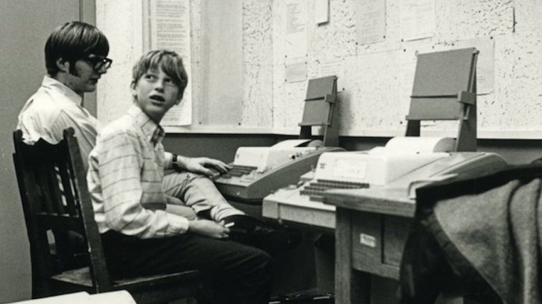 Young Bill Gates sitting at old computer with Paul Allen