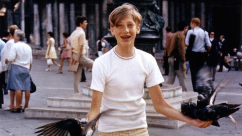 A young Bill Gates holding birds
