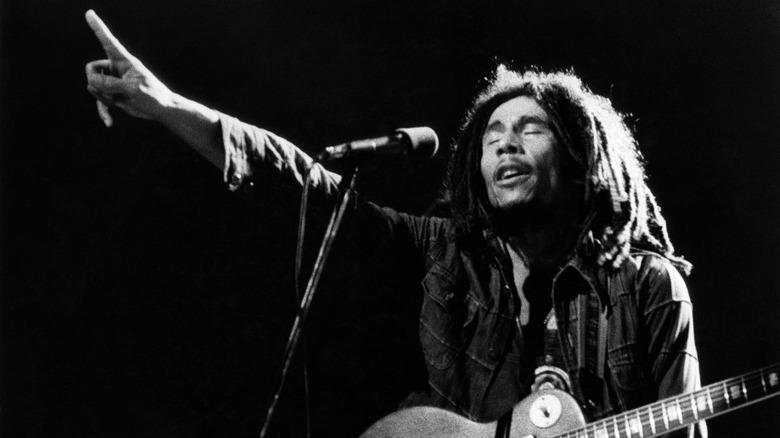 Bob Marley holding up one finger while performing onstage